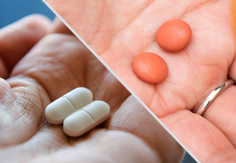 Two hands holding pills, one white and one brown.