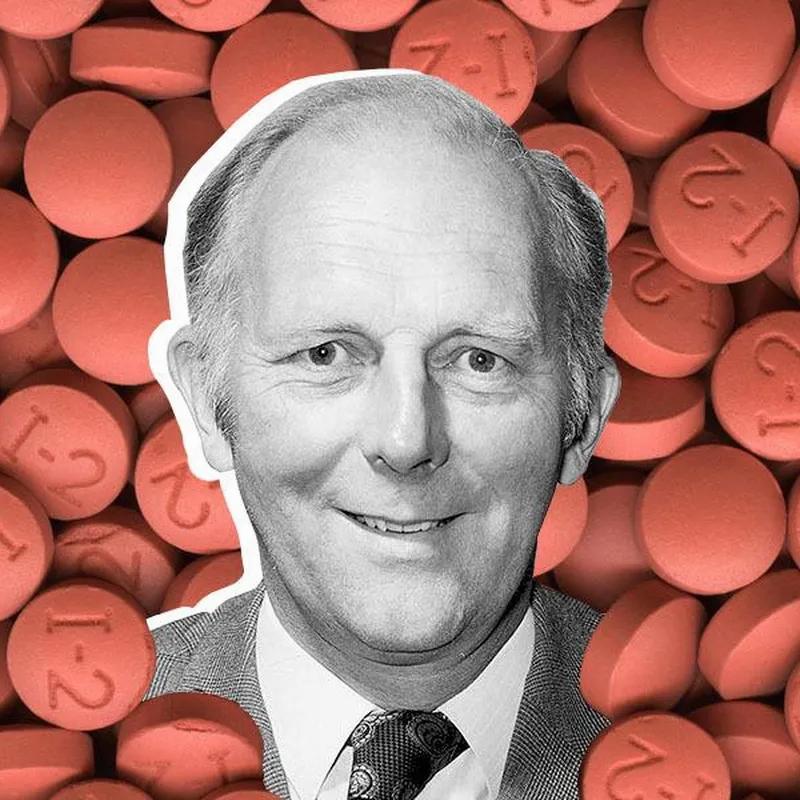 A black and white portrait of a man with a background of red pills.