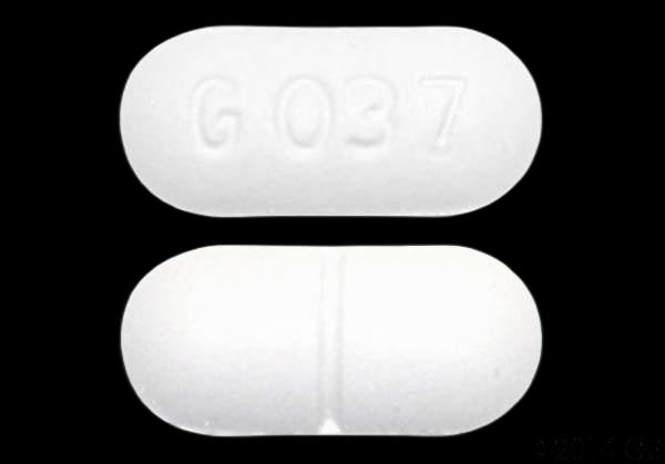 A white oblong pill with the imprint 6037 on one side and a score line on the other.