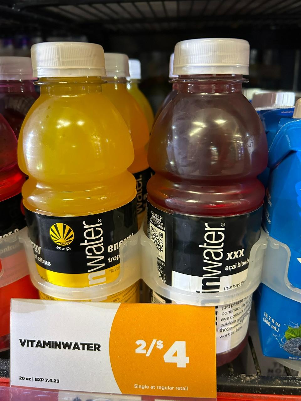 Two bottles of Vitamin Water on a shelf.