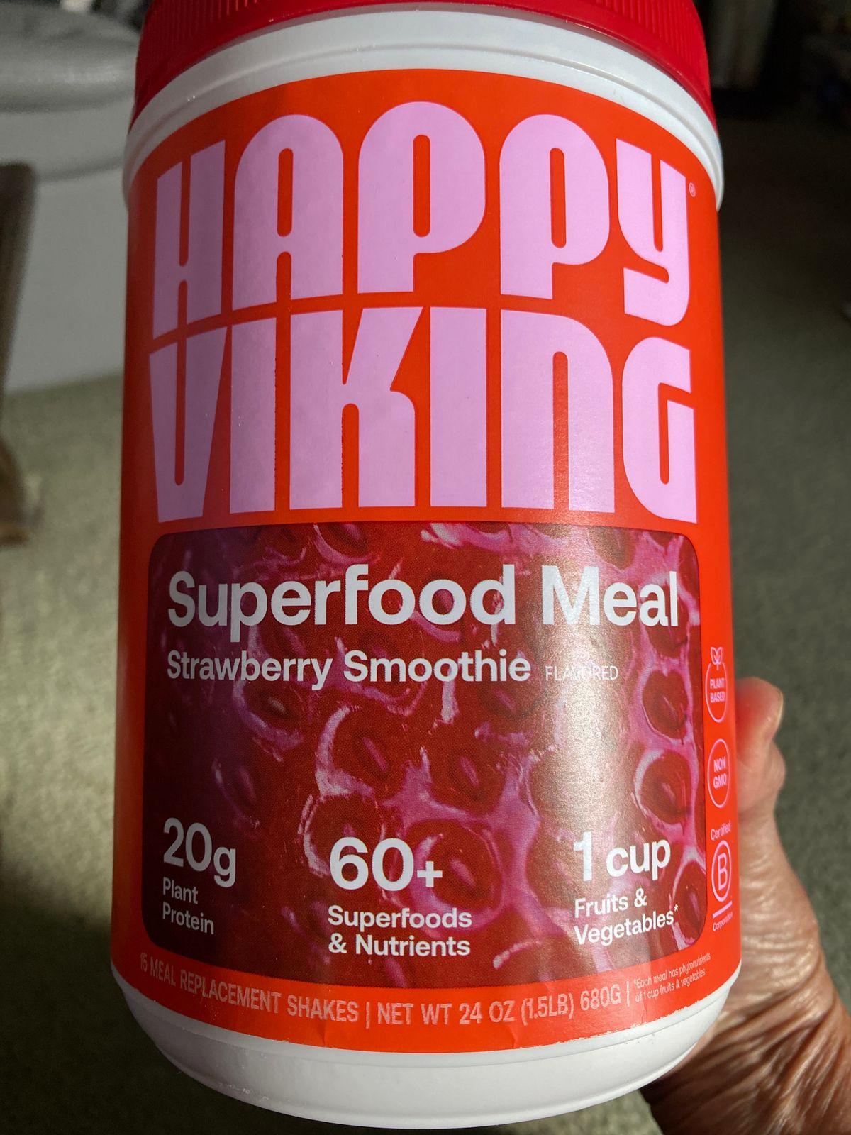 A pink tub of Happy Viking Superfood Meal in the flavor Strawberry Smoothie.