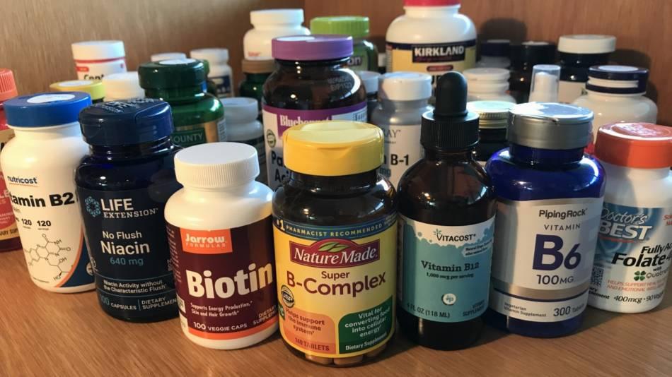 A collection of various bottles and containers of vitamins and supplements.