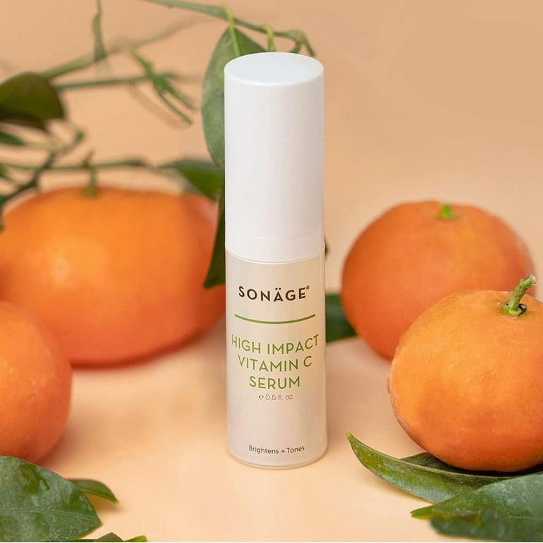 A bottle of Sonäge High Impact Vitamin C Serum is shown next to a pile of mandarin oranges.