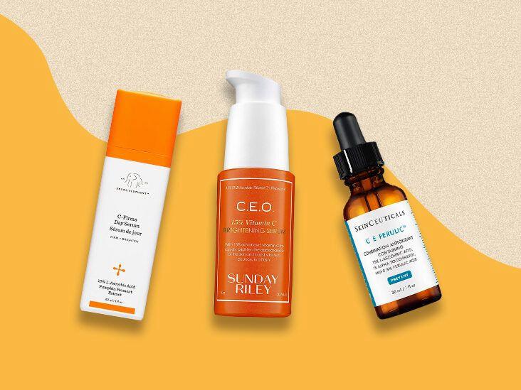 Three bottles of different facial serums with orange liquid inside, placed on a beige background with an orange wave at the bottom.