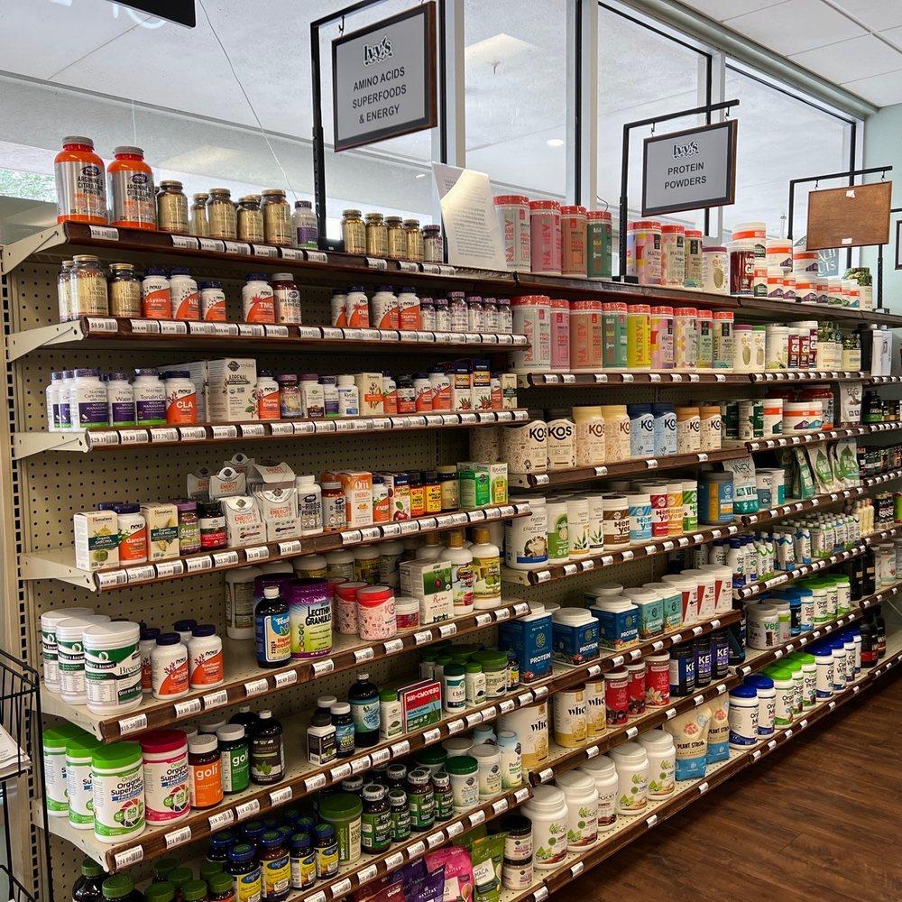 Aisle of a store with shelves stocked full of various supplement bottles and boxes.