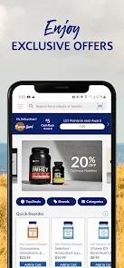 The image shows a mobile phone with the Myprotein app open on the screen, displaying a range of products and exclusive offers.