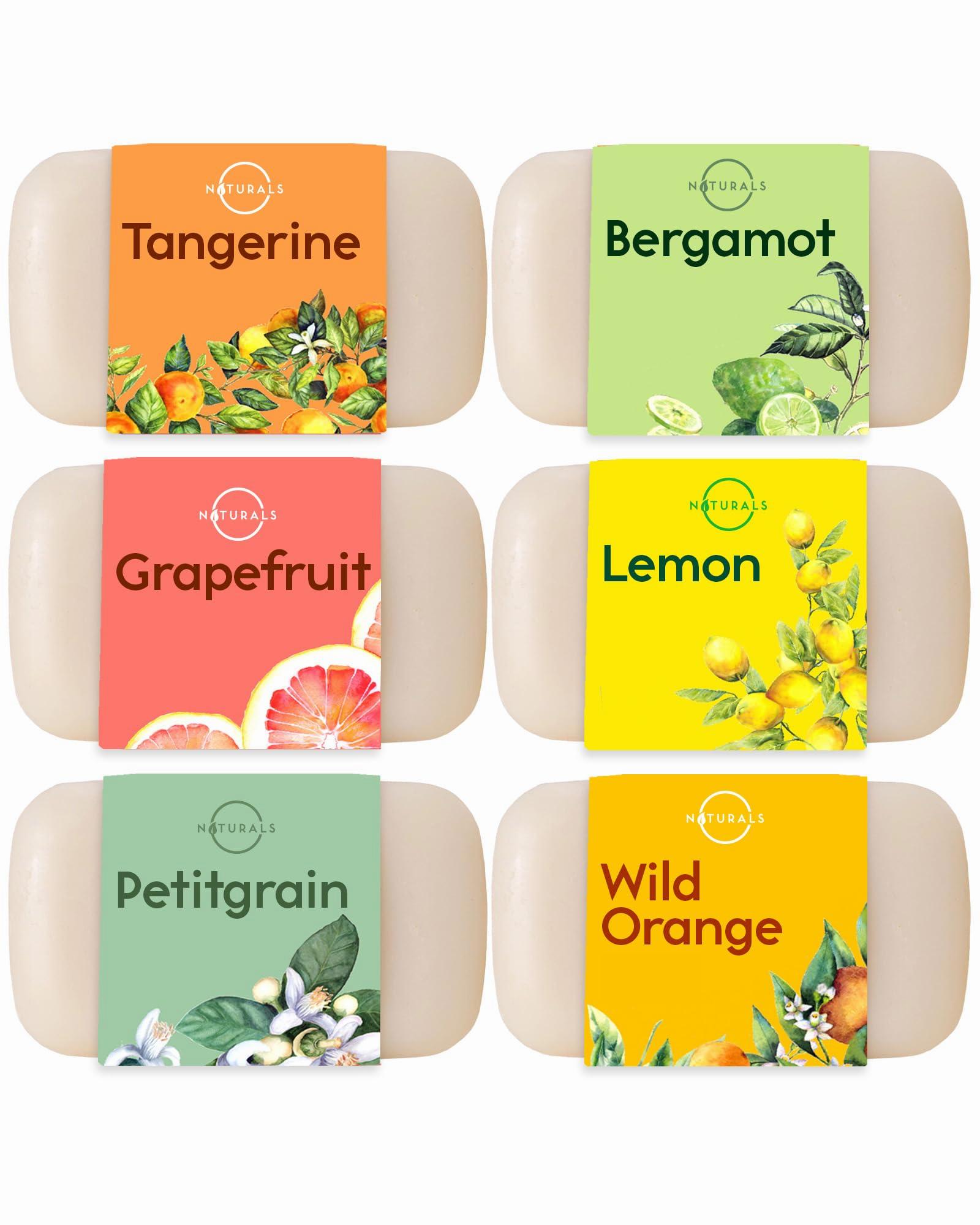 Six unwrapped bars of soap with labels indicating the scents: tangerine, bergamot, grapefruit, lemon, petitgrain, and wild orange.