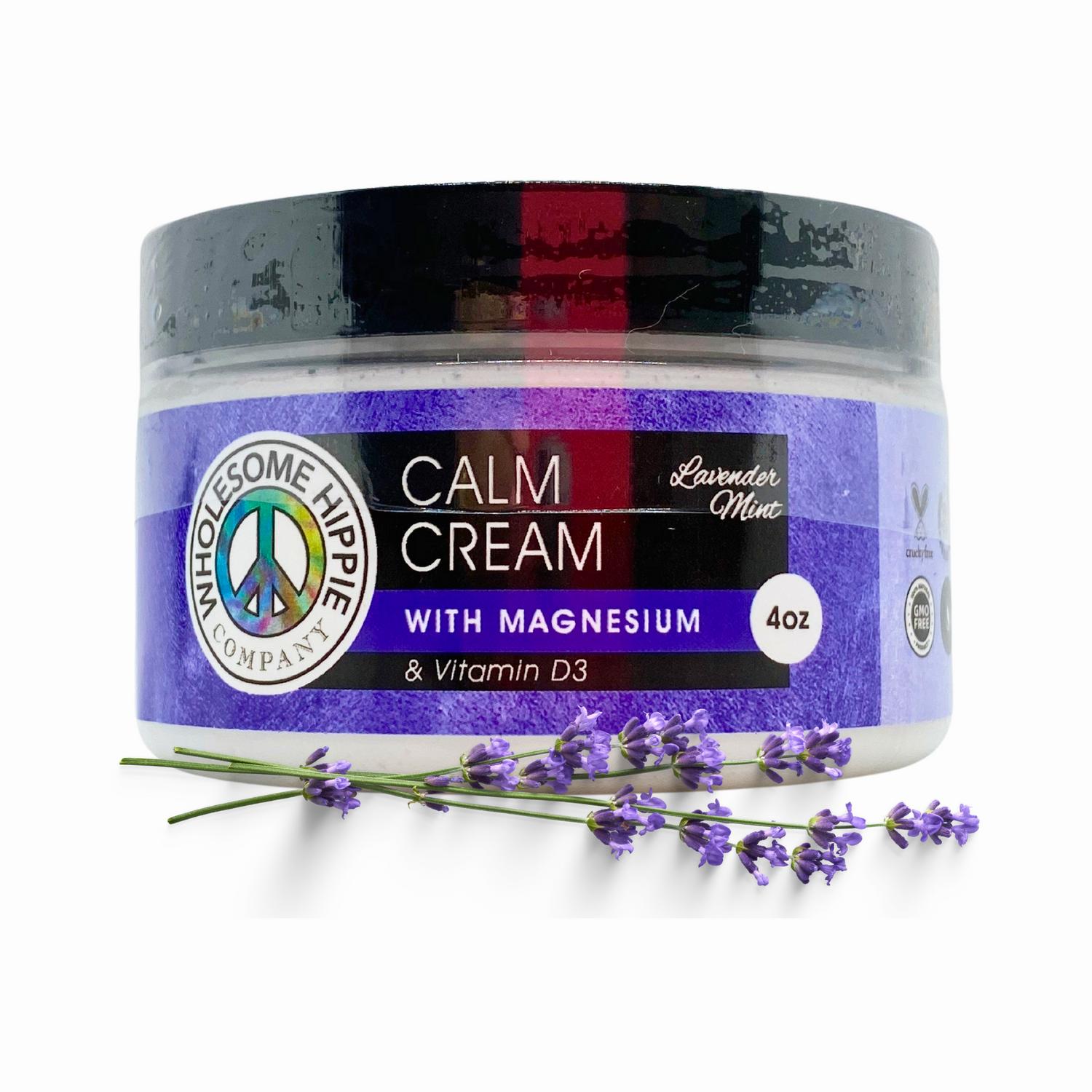 A black jar of lavender mint calm cream with magnesium and vitamin D3 sits in front of lavender flowers.