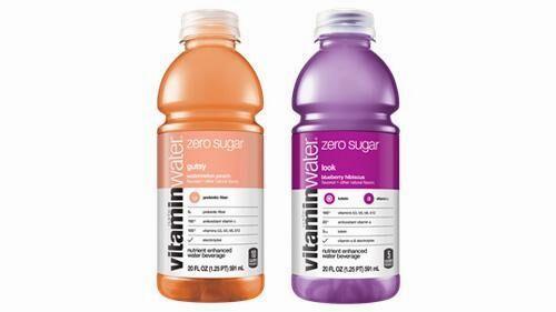 Two bottles of Vitamin Water, one orange-flavored and one purple-flavored.