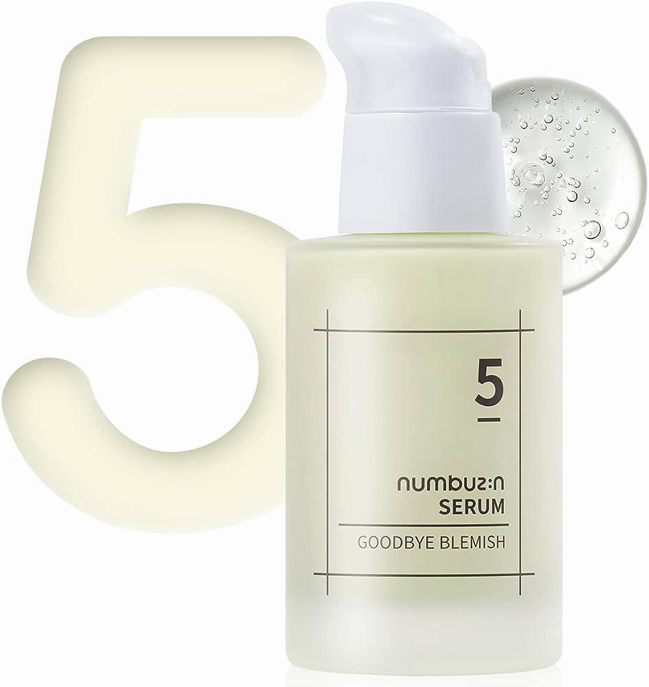 A clear bottle of serum with a white lid and a white label with black text that reads numbuz:n serum goodbye blemish.