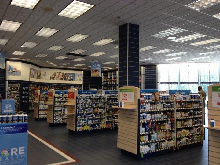 The inside of a GNC store, with shelves stocked with various health and wellness products.