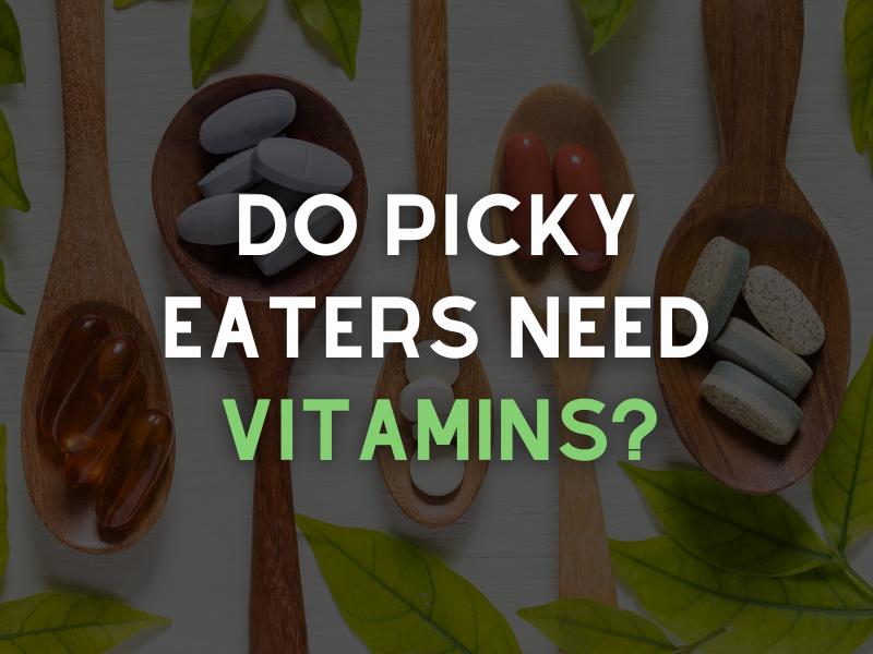 Wooden spoons hold various colorful pills and capsules on a white surface with green leaves in the background, and text overlaid reads Do picky eaters need vitamins?