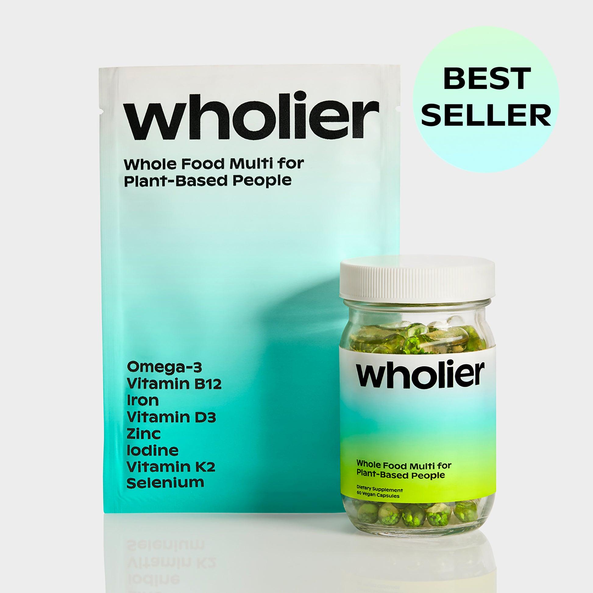 A white bottle of Wholier, a plant-based multivitamin, sits in front of a blue bag of the same product.