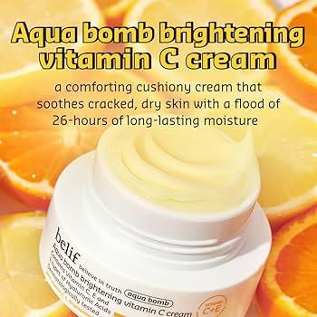A jar of Belif Aqua Bomb Brightening Vitamin C Cream is shown sitting on top of sliced oranges.