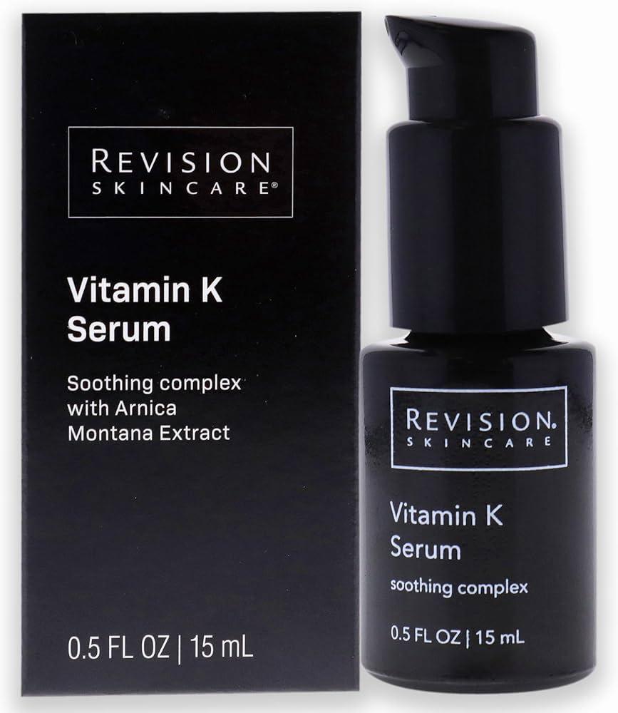 A black Revision Skincare box with a black pump-top bottle of Vitamin K Serum in front of it.