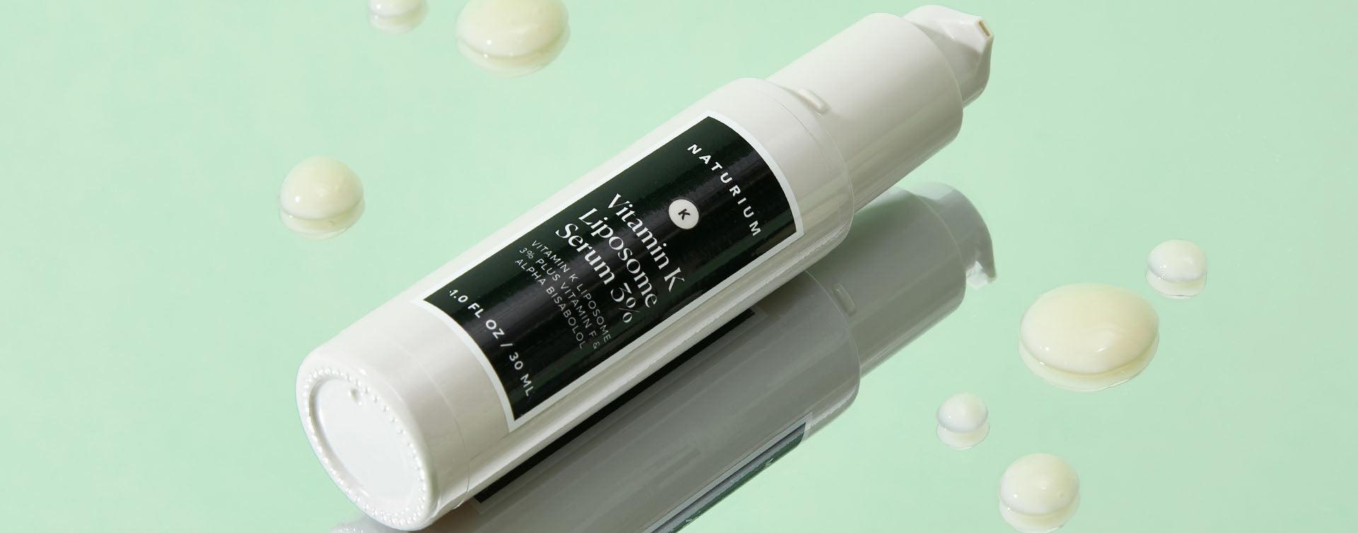 A white bottle of Naturium Vitamin K Liposome Serum 3% with a white cap and a white label with black text.