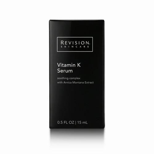 A black Revision Skincare box with a black label that has white text reading, Revision Skincare, Vitamin K Serum, soothing complex with Arnica Montana Extract, 0.5 FL OZ | 15 mL.