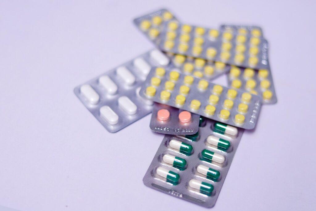 Different types of pills and capsules in blister packs.
