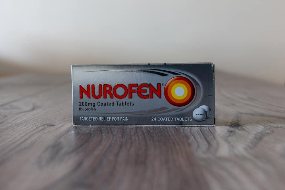 A box of Nurofen tablets on a wooden table.