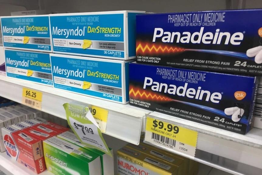 A shelf of over-the-counter pain relief medication.