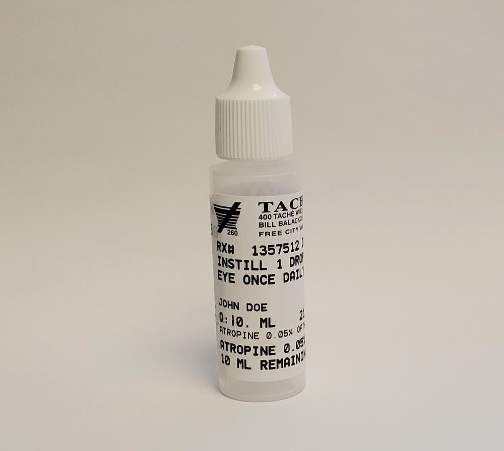 A small translucent bottle with a white cap and white label containing eye drops.
