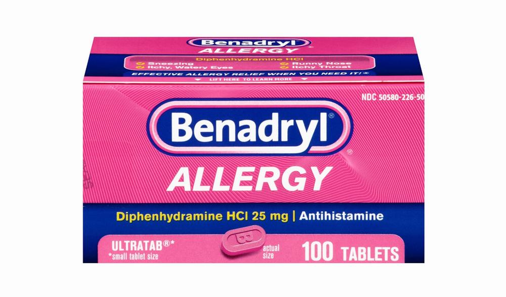 A pink and white box of Benadryl Allergy tablets, an antihistamine used to treat allergies.