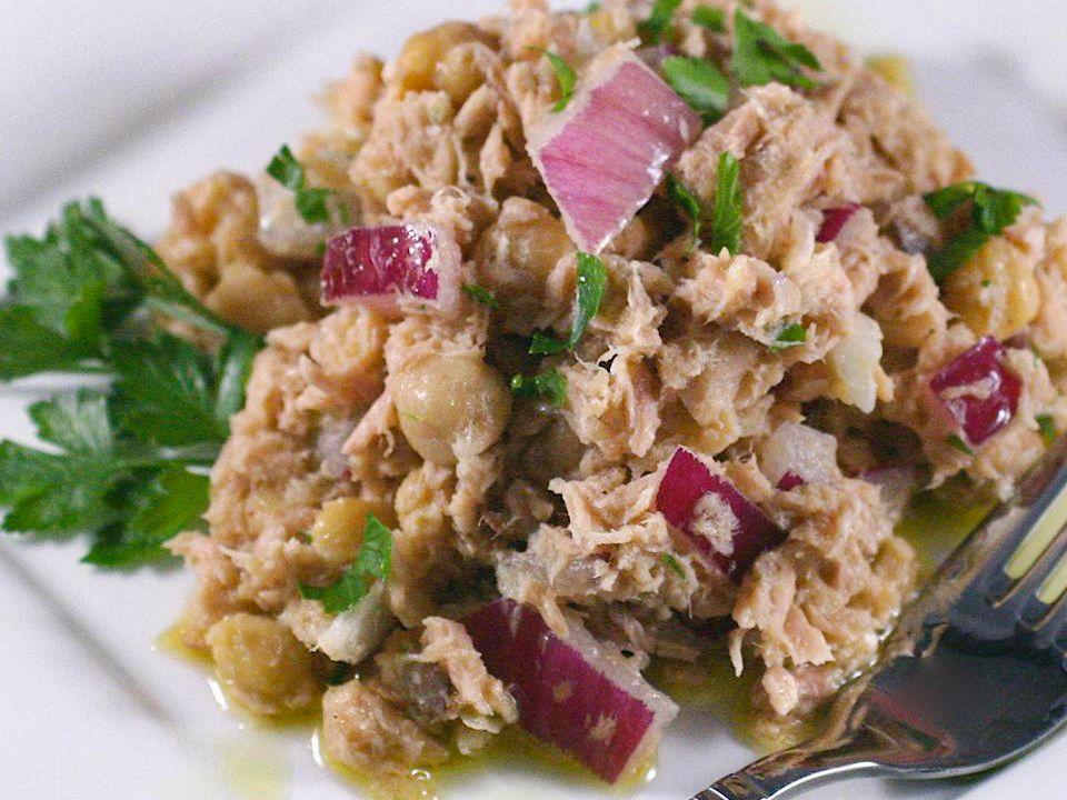 A photo of a tuna salad made with chickpeas, red onion, and parsley.