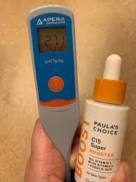 Apera Instruments PH meter displaying a pH of 2.71 next to a bottle of Paulas Choice C15 Super Booster.