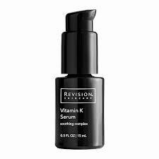 A black bottle of Revision Skincare Vitamin K Serum with a black pump lid.