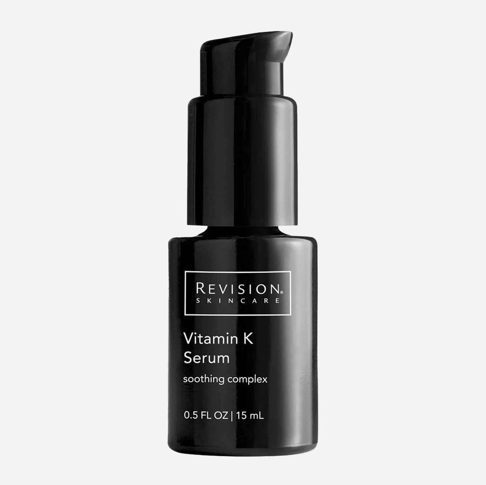 A black bottle of Revision Skincare Vitamin K Serum with a black pump lid.