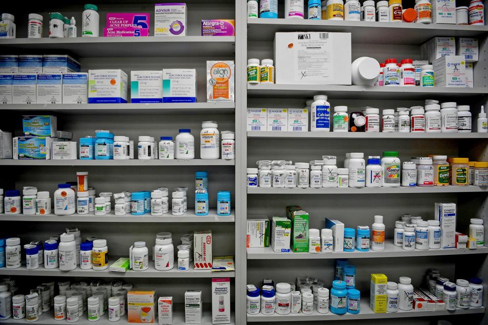 A variety of medications are on the shelves of a pharmacy.