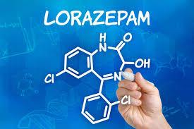 A hand is drawing the chemical structure of Lorazepam on a blue background.