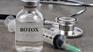 A vial of Botox next to a syringe and stethoscope.