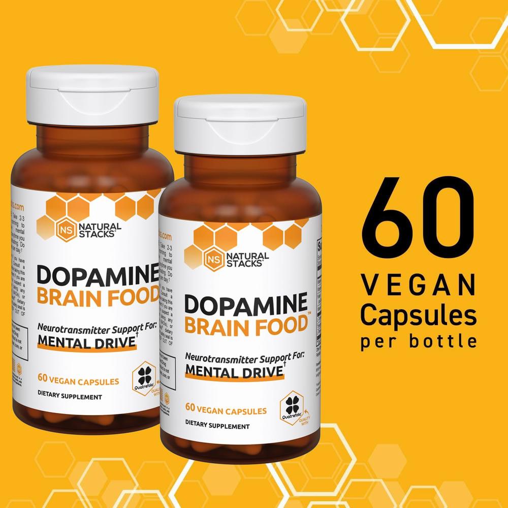 Two bottles of Natural Stacks Dopamine Brain Food capsules, a nootropic supplement that supports mental drive.