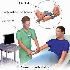 A nurse is correctly identifying a patient using a bar code scanner.
