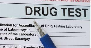 A pen is placed on a form titled Drug Test.