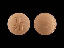 A light brown round pill with TL debossed on one side and 211 on the other.