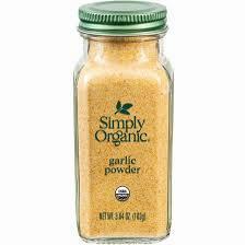 A small glass jar of Simply Organic Powder with a green lid.